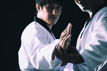 Taekwondo Training Two-Man Poses checking on black background close up.Perfect for sports...