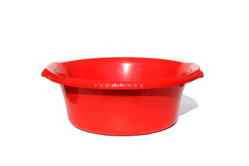 A red plastic basin stands on a white background.