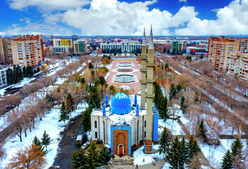 drone flight over city administration building akimat and central square of Ust Kamenogorsk, winter cloudy day. - obrazy, fototapety, plakaty