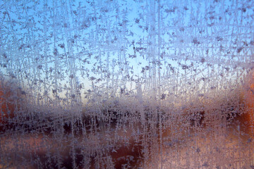 Frosty pattern on winter window glass. Abstract natural background.