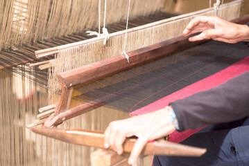 A woman works a handloom in Laos, Lao Prabang region. January 12, 2024