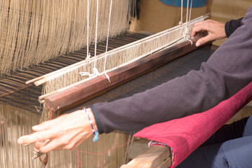 A woman works a handloom in Laos, Lao Prabang region. January 12, 2024