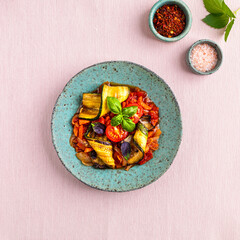 Grilled zucchini with vegetables in tomato sauce. the concept of vegetarian food.