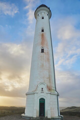 Lighthouse at sunset in coastal city Hvide Sande Denmark