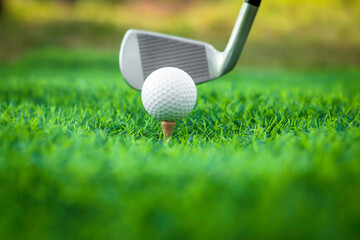 Golf ball close up on tee grass on blurred beautiful landscape of golf background. Concept...