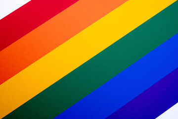 Rainbow flag on a light background. LGBT flag. LGBTQIA Pride Month in June. Lesbian-gay-bisexual-transgender. Gender equality. Human rights and tolerance. Rainbow flag - obrazy, fototapety, plakaty
