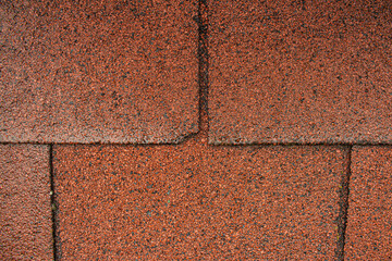 Texture of a rough tile-like roof in red color