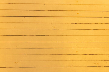 Wooden boards painted with yellow paint. Background Texture