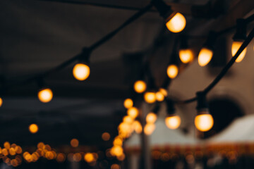Blurred background of outdoor restaurant with abstract bokeh light. Abstract Blurred image of Night...