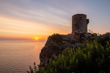 A 16th century watchtower called Torre de Verger on the island of Mallora, Spain. Landscape at...