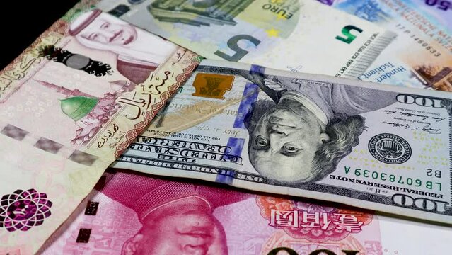 A cinematic shot of the world's different currencies while rotating,  with The US Dollar in the middle, representing the dominance of the US Dollar over all other currencies globally. 