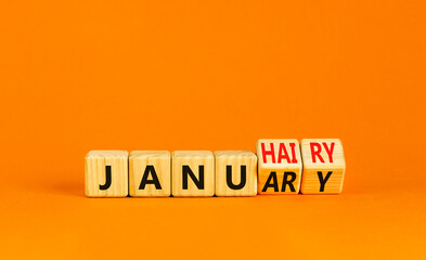 Januhairy or January symbol. Concept words Januhairy or January on beautiful wooden blocks. Beautiful orange table orange background. Social issues Januhairy or January concept. Copy space.