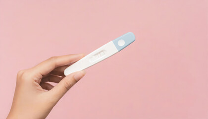 Young woman hand holding pregnancy test on pastel pink background with copy space - obrazy, fototapety, plakaty