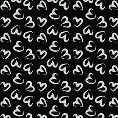 Seamless background pattern with hand drawn textured hearts. Black and white.