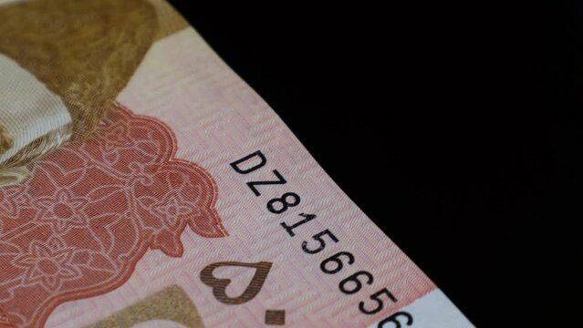 A closeup of security features of the 5000 Pak Rupee Bank Notes stack, 5000 is highest denomination of Pakistani bank notes