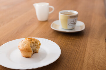 Bite-sized muffin with coffee and milk for breakfast