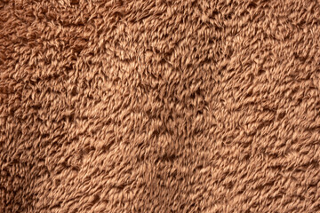 Texture of a brown faux fur as a background.
