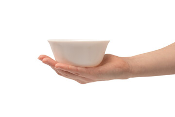Female hand is holding a ceramic bowl isolated on white background. - obrazy, fototapety, plakaty