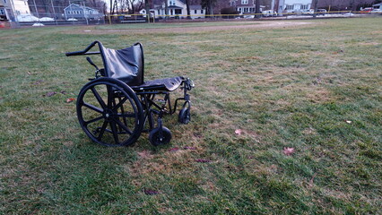 Abandoned wheelchair by baseball diamond outdoor photography found object