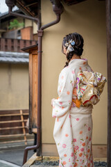 Japanese Female Kimono Portrait back view photography. Kyoto, Japan. Japanese traditional buildings background.