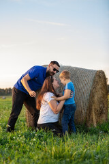 Fun family games with their son in the summer meadow on a warm beautiful day