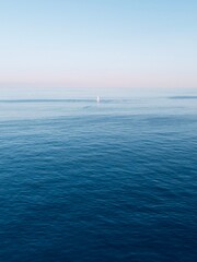Aerial view boat sailing in the mediterranean sea with the sunset in the background.