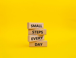 Small Steps Every Day symbol. Wooden blocks with words Small Steps Every Day. Beautiful yellow background. Business and Small Steps Every Day concept. Copy space.