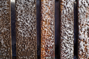 Winter background old bridge boards covered with ice and snow.