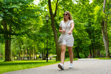 Healthy lifestyle - woman walking in city park 