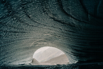 Rounded tunnel ice cave view from the inside. Cueva de Jimbo, Ushuaia, Tierra del Fuego
