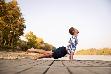Full length of man practicing yoga outdoor
