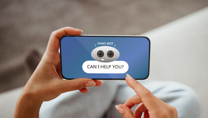 Woman hands using chatbot on smartphone, home interior