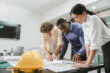 Team of architects working together on project. engineer Hand Drawing Plan On Blue Print with architect equipment, Architects discussing at the table, team work and work flow construction concept.