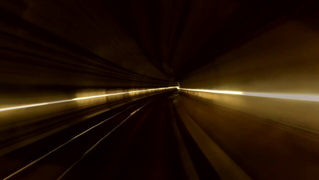Hyperlapse of automatic train moving in tunnel for transit to terminal in International Airport from Barcelona, Spain. Time lapse video a fast-paced journey through a dark tunnel