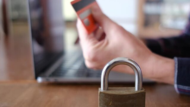 Woman typing on computer keyboard. Computer padlock card payment. Security and protection of secure payments, data security, security, and decentralization of transactions and data.