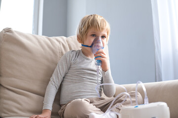 little boy using steam inhaler nebulizer. health medical care.
