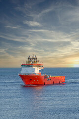 Fototapeta premium Ship arriving at Aberdeen harbour after passing Girdle Ness Lighthouse
