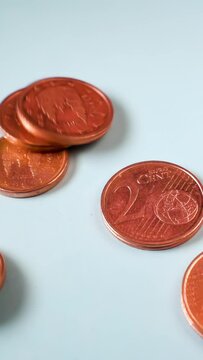 1 and 2 euro cent coins falling in slow motion. Suitable for the Uniform rounding rules for cash payments and circulation of 1 and 2 cent coins public consultation from european comission. Vertical