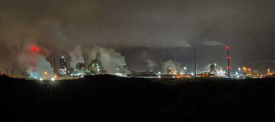 Panoramic night view of blast furnaces of a steel plant near IJmuiden, Netherlands