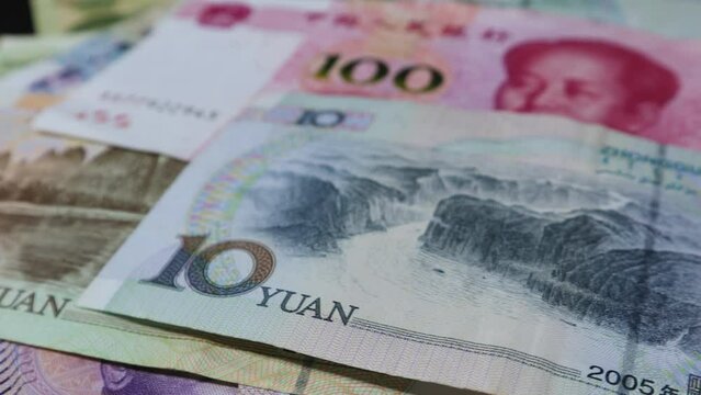 Chinese Yuan of different denominations of 10, 20, 50 and 100 ; rotating on an automatic display stand. 
