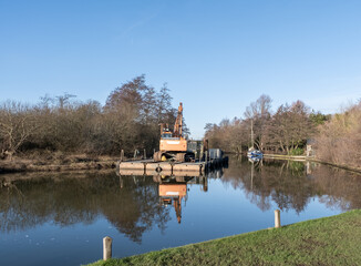 Obraz premium Dredger on the River Bure at Belaugh Staithe, Norfolk Broads national park