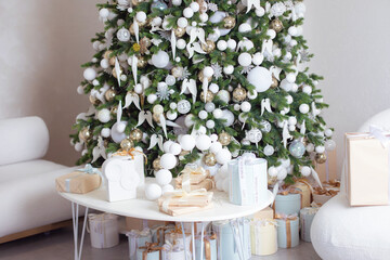 Christmas and New Year home decoration in white and golden colors
