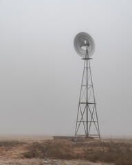 Water pumping windmill on a fogy morning in Texas