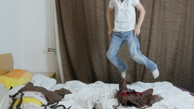 Cute boys dressed in pirate costumes jumping on the bed. High quality 4k footage