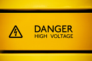 Close up of black danger high voltage sign on yellow background - 709298553