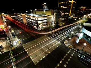 Fototapeta na wymiar Downtown busy intersection at night with streaking car lights