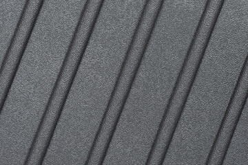 A grooved rubber material. Abstract background pattern with diagonal grooves. Graphite wallpaper