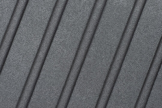 A grooved rubber material. Abstract background pattern with diagonal grooves. Graphite wallpaper