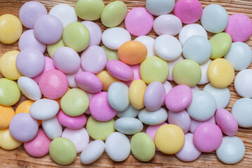 A stack of pastel colors glazed draggees. Colorful chewy candies as background