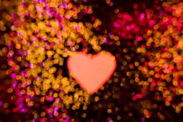 Red paper heart on a black background with blurred golden glitters, decorations for Valentine's Day, Mother's Day. Textures